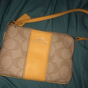 Yellow patterned coach handbag